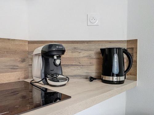 a coffeemaker and a coffee maker on a counter at Le Petit Jules in Dijon