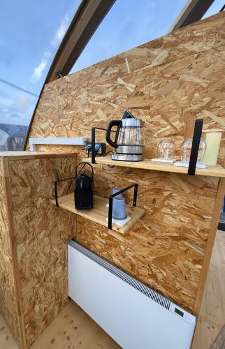 a kitchen with wooden counters and shelves on a wall at Wigwam Bel'Etoile in Bellencombre