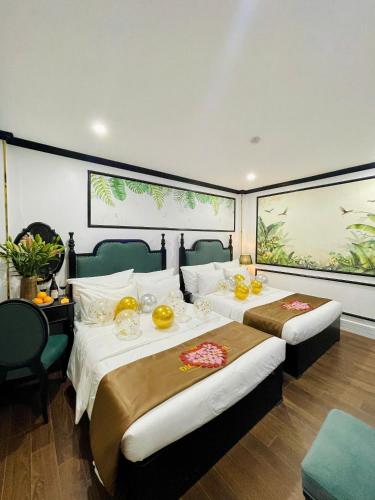 a hotel room with two beds with food on them at Diamond Hotel CoLinh in Long Biên
