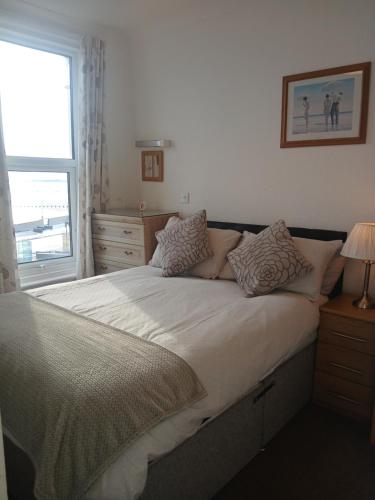 a bedroom with a large bed with a window at Rowntree Seaview Holiday Apartments in Bridlington
