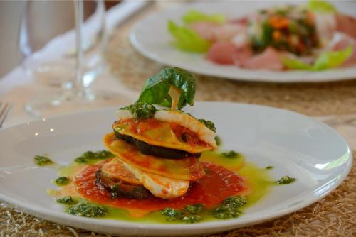 a white plate with food on a table at Guesia Village Hotel e Spa in Foligno