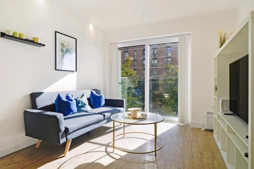a living room with a couch and a table at New-Build 1-Bed Apartment in Luton in Luton