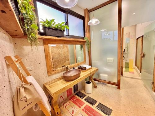 a bathroom with a wooden sink and a window at 隱山居 海景包棟2-10人 in Jiufen