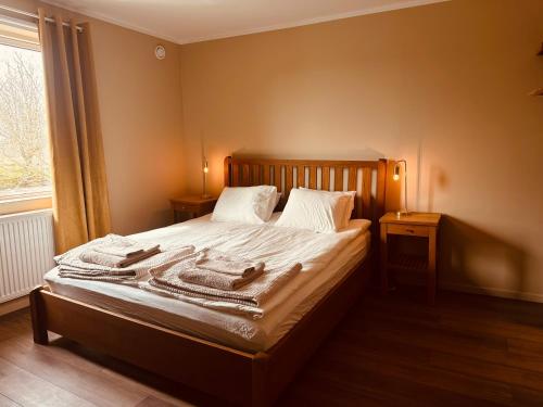 a bedroom with a bed with towels on it at SteneBo in Stenestad