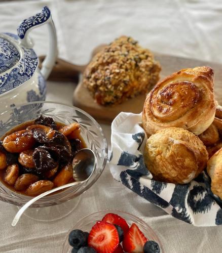 a table topped with plates of pastries and fruit at Dunvegan Steading Bed and Breakfast in Dunvegan