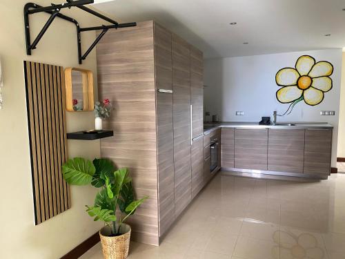 a kitchen with a large wooden cabinet with a sink at Golden Flower in Tacoronte