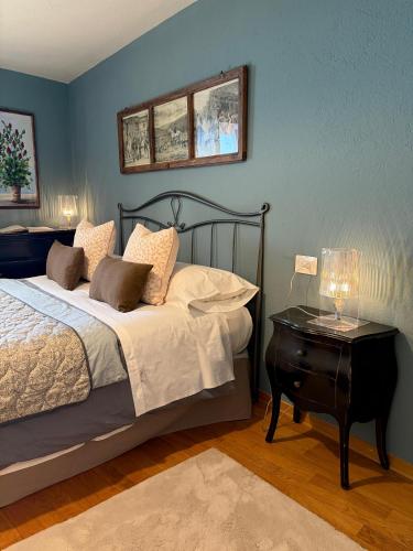 a bedroom with a bed and a table with a lamp at Maison Jacquemin in Saint-Pierre