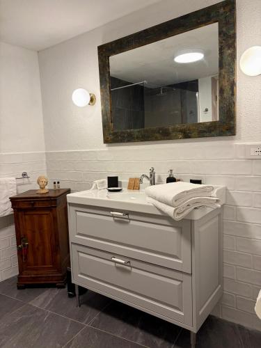 a bathroom with a sink and a mirror at Maison Jacquemin in Saint-Pierre