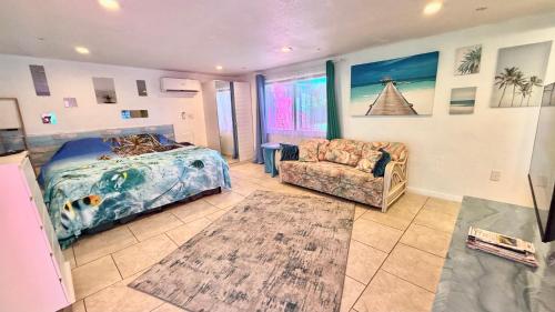a bedroom with a bed and a couch at Close to beaches with hot tub and large garden in Sarasota