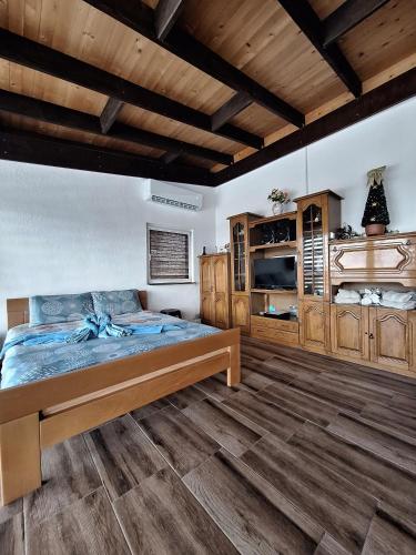 a bedroom with a large bed and wooden cabinets at The Mountain House Doris in Kruševo