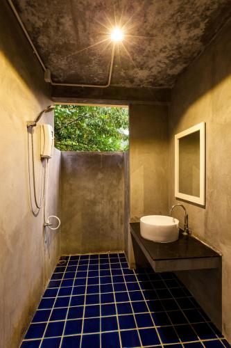 a bathroom with a tub and a sink at Palms Hill Resort in Phangnga