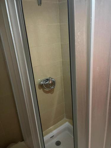 a shower with a glass door next to a toilet at Magnifique Appartement à Louer C14 Jnane Dalya in Bouznika