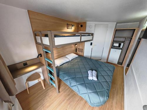 a small room with a bunk bed and a ladder at HOTEL PREMIERE CLASSE Rouen Sud Oissel in Saint-Étienne-du-Rouvray