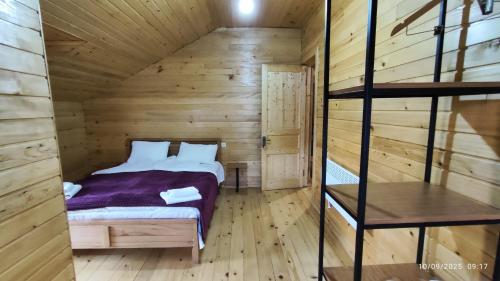 a bedroom with a bed in a wooden cabin at Gaul Gavkhe Hotel in Khalde