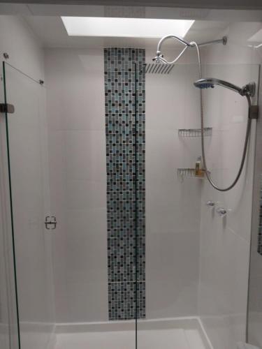 a bathroom with a shower with a glass door at Casa del Bosque in Suesca