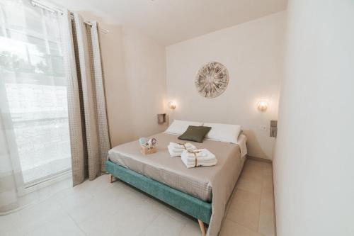 a bedroom with a bed with towels on it at Trullo Alisia - TrulloExperience in Putignano