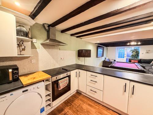 a kitchen with white cabinets and a sink at Perfect House for Group Getaways - Sleeps 14 - 4BR in Newcastle upon Tyne