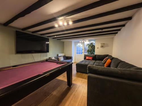 a living room with a pool table and a couch at Perfect House for Group Getaways - Sleeps 14 - 4BR in Newcastle upon Tyne