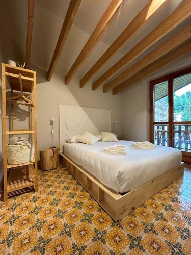 a bedroom with a large bed in a room at Il Faggio Rosso Apartment in Vernante