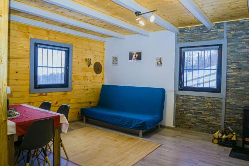 a blue bench in a room with a table at Independent Chalet in Şirnea