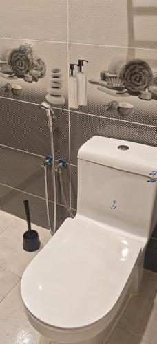 a bathroom with a white toilet in a room at شقق درة المصيف in Taif