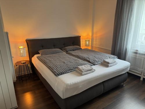 a bedroom with a bed with two pillows on it at Ferienwohnung Arminius in Detmold