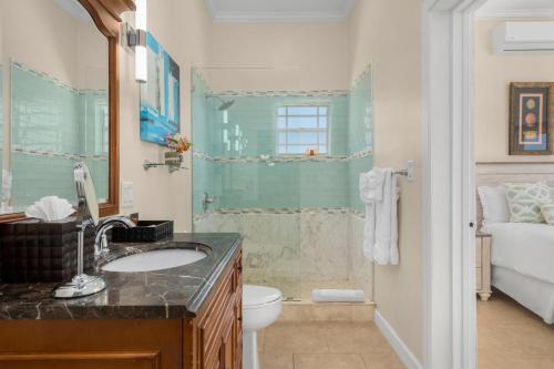a bathroom with a sink and a toilet at The Babbington Villa in Taylor Bay Beach