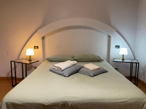 a large bed with two pillows on top of it at Paradise Suites - Brignole Station - Best Price Rooms - ALWAYS OPEN in Genoa
