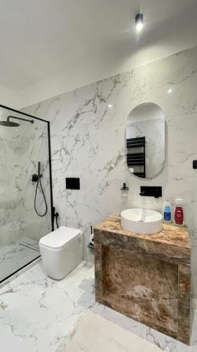a white bathroom with a sink and a toilet at Paradise Suites - Brignole Station - Best Price Rooms - ALWAYS OPEN in Genoa