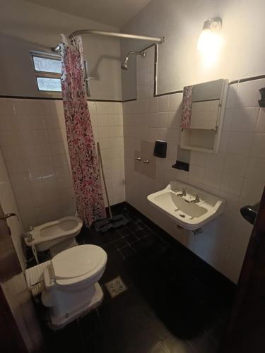a bathroom with a toilet and a sink at Deptos Pablos, Apto No 4 in Villa Gesell