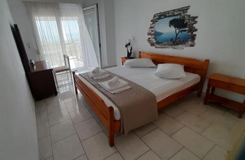 a bedroom with a bed and a mirror on the wall at Georgia's Summer House in Karianí