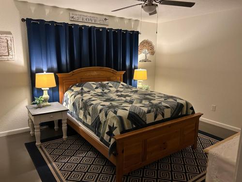 a bedroom with a bed with a blue curtain at Turlocks Little Palace in Turlock