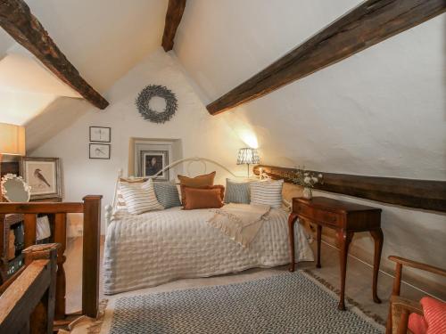 an attic bedroom with a bed and a desk at 8 Welsh Street in Bishops Castle