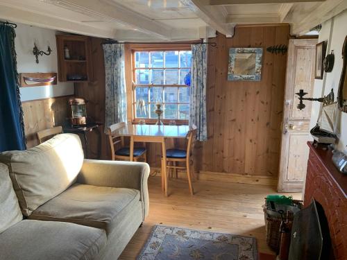 a living room with a couch and a table at Fisherman's Cottage, Staithes in Staithes