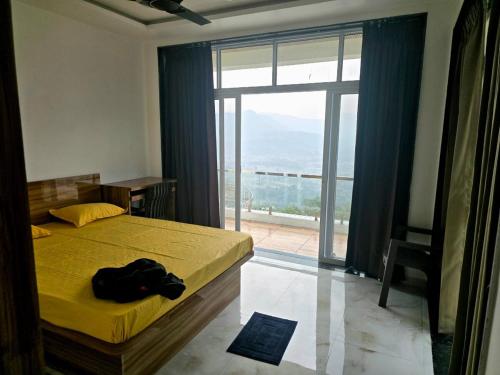a bedroom with a bed and a large window at Devs Villa Amansara above the sky in Pune