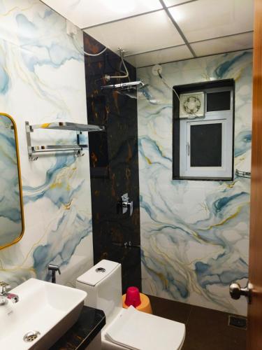 a bathroom with a sink and a toilet at Devs Villa Amansara above the sky in Pune