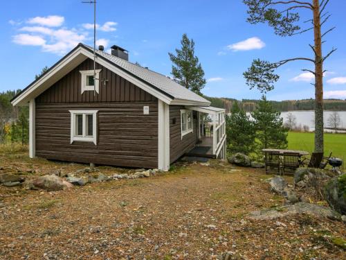 a log cabin with a picnic table and a bench at Holiday Home Koskiharju by Interhome in Säynetlahti