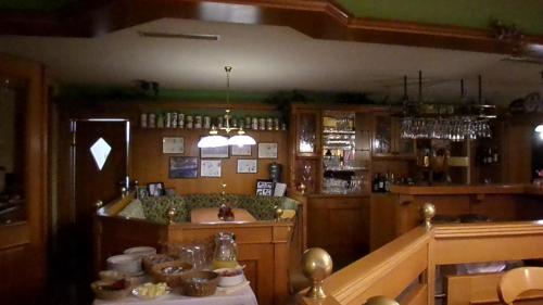 a kitchen with a bar with a table in a room at Hotel Schützenhaus in Bad Düben