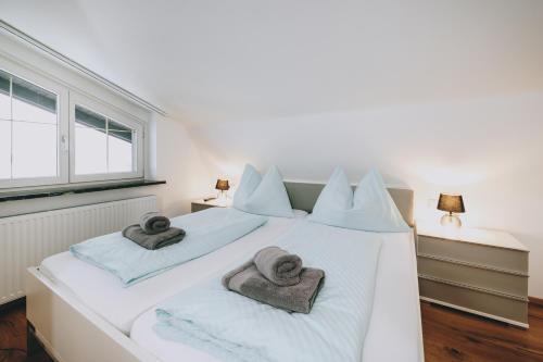 a bedroom with two beds with towels on them at Mooslodge in Kaprun