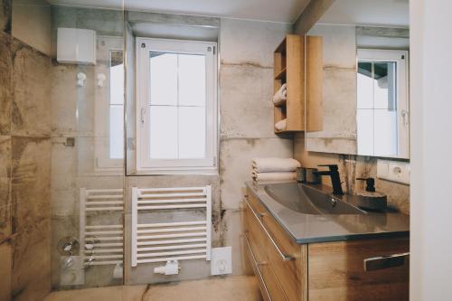 a bathroom with a sink and a window at Mooslodge in Kaprun