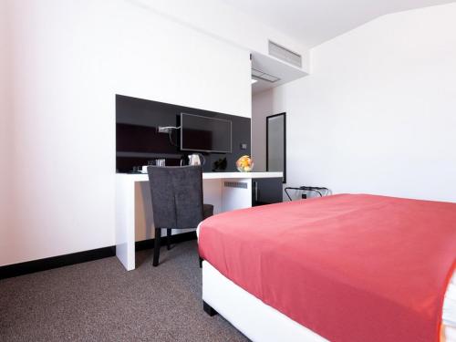 a hotel room with a red bed and a desk at Nova City Garni Hotel Signature Collection in Belgrade