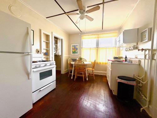 a kitchen with white appliances and a table with chairs at The Wadsworth Suite A2 in Hartford