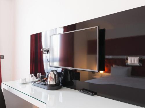 a computer monitor on a desk in a hotel room at Nova City Garni Hotel Signature Collection in Belgrade