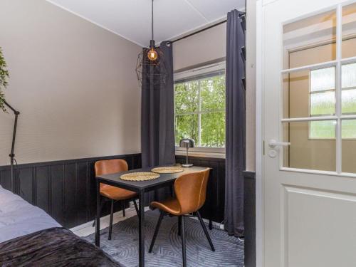 a room with a table and two chairs and a bed at Holiday Home Levin mini by Interhome in Sirkka