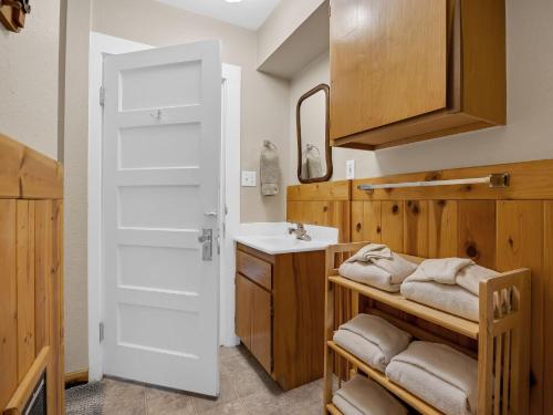 a bathroom with a sink and a white door at Rockin Rhody Retreat in Rhododendron