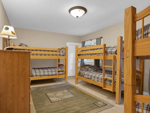 a room with three bunk beds and a lamp at Rockin Rhody Retreat in Rhododendron