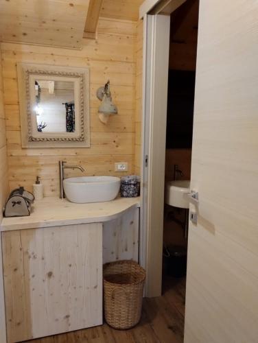 a bathroom with a sink and a mirror at Etna Baite Milo in Milo