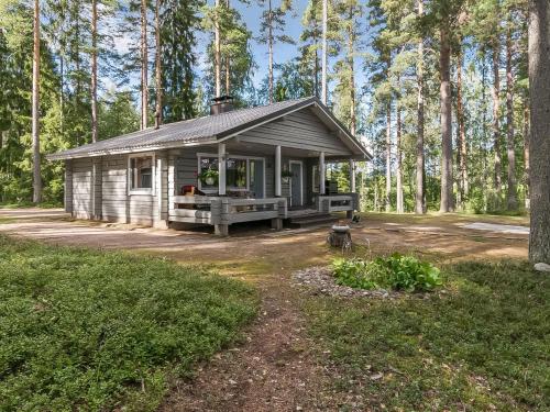 a small cabin in the middle of a forest at Holiday Home Kivilöytö by Interhome in Mouhu