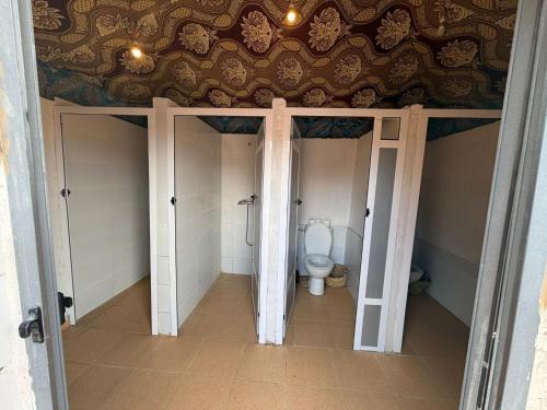 a bathroom with a toilet in a room at Mustapha Camp Merzouga in Merzouga