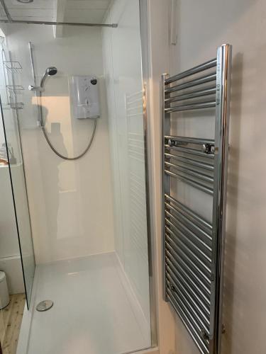a shower with a glass door in a bathroom at Old Jack's Cottage, Staithes in Staithes